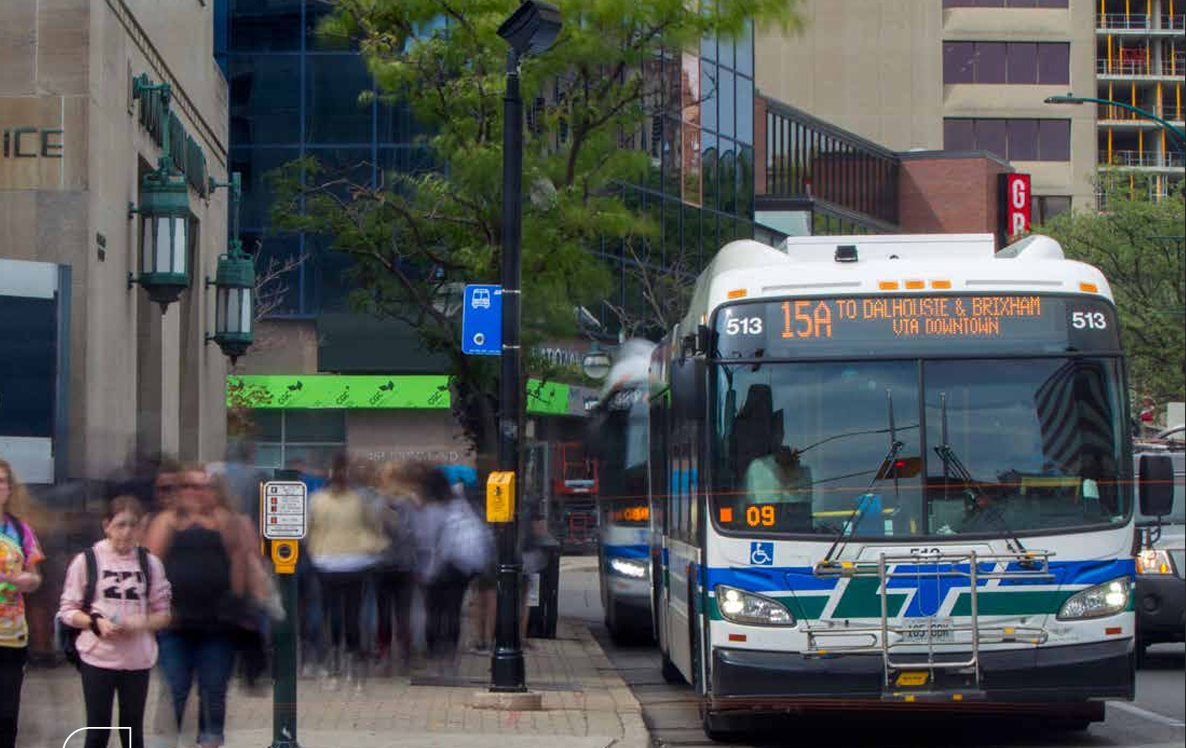 People getting on and off a London Transit Commission bus in downtown London Ontario Canada
